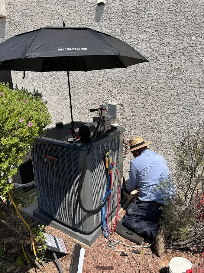 HVAC technician performing outdoor AC maintenance in Mountain Home